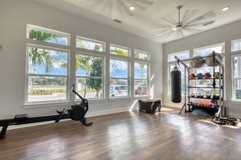 the home gym has plenty of windows and a large view